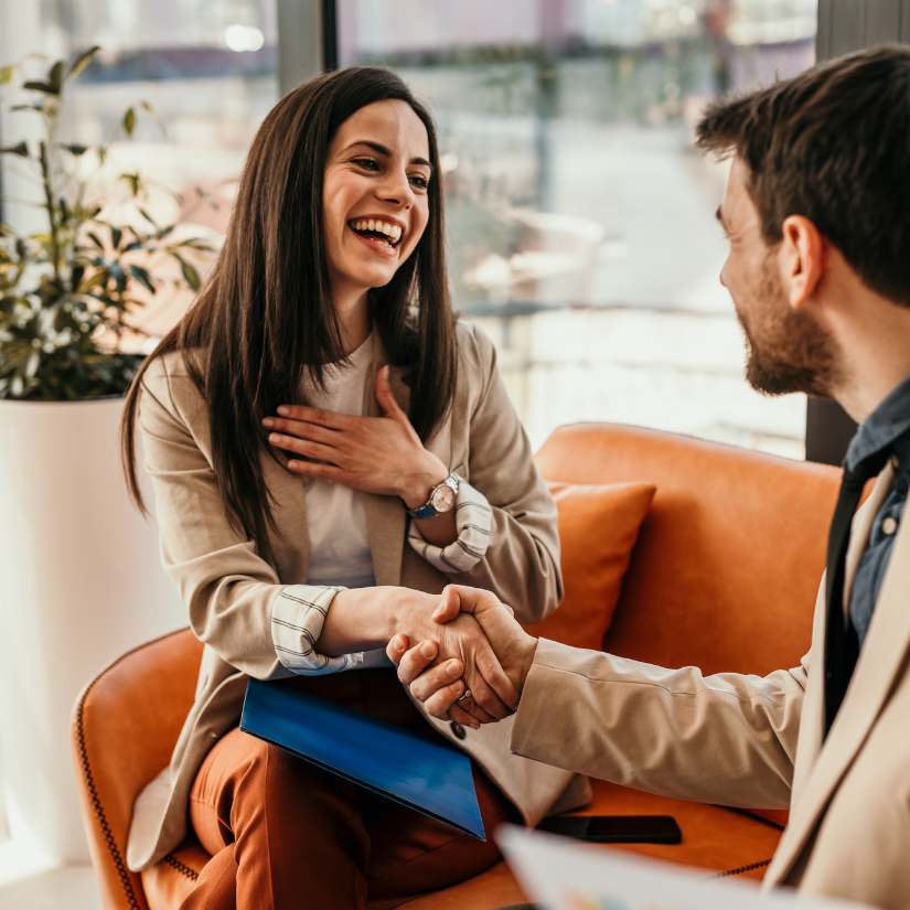 A person being interviewed and shaking hands