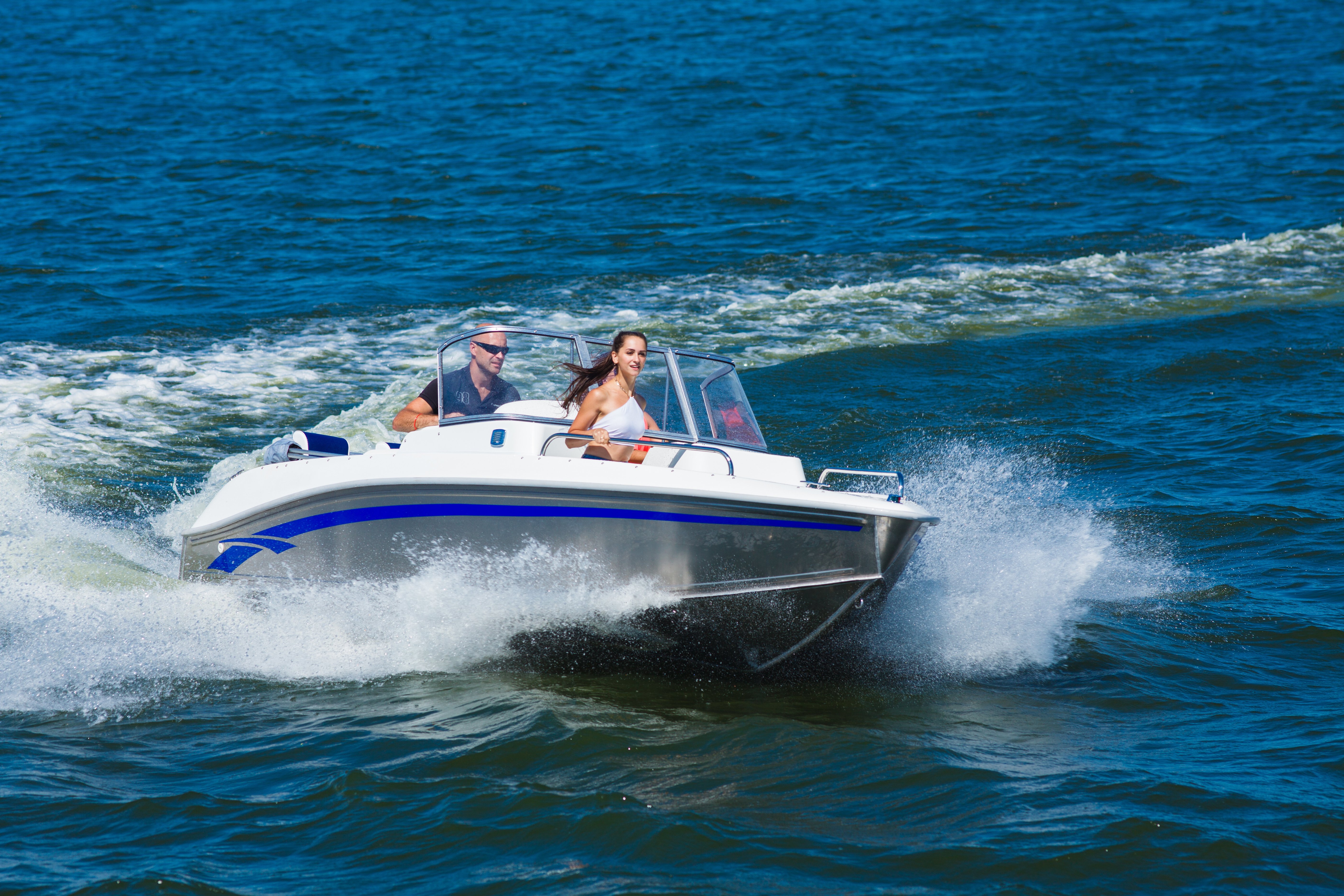 Couple riding in a boat on a lake.