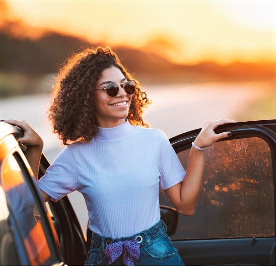 Woman getting out of her car after getting an Auto Loan.
