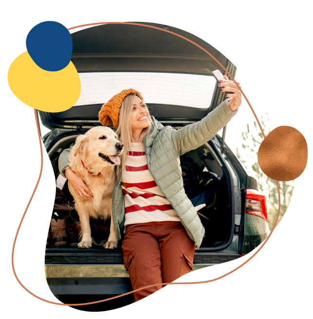 Woman taking selfie with her dog after getting a car loan.