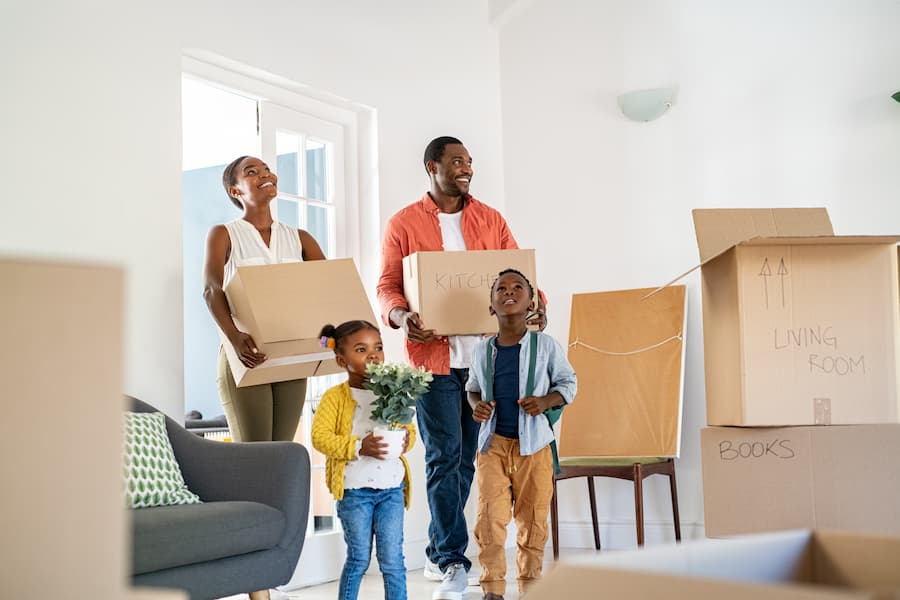 A happy family move into the home they bought with a fixed interest rate mortgage.
