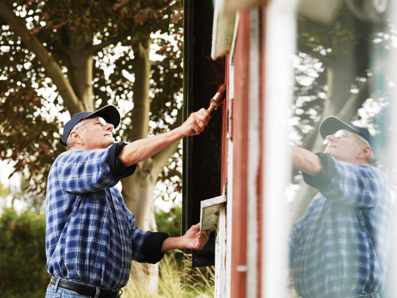 older-man-painting-side-of-house