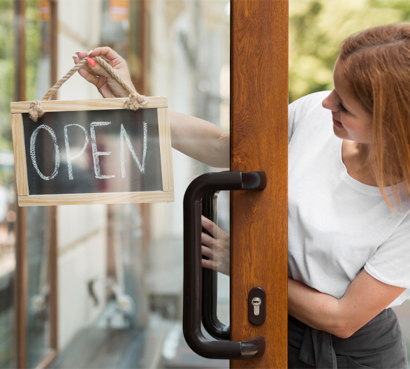 business owner holding an open sign