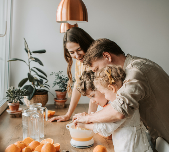 Family Hand Pressing Orange Juice Together