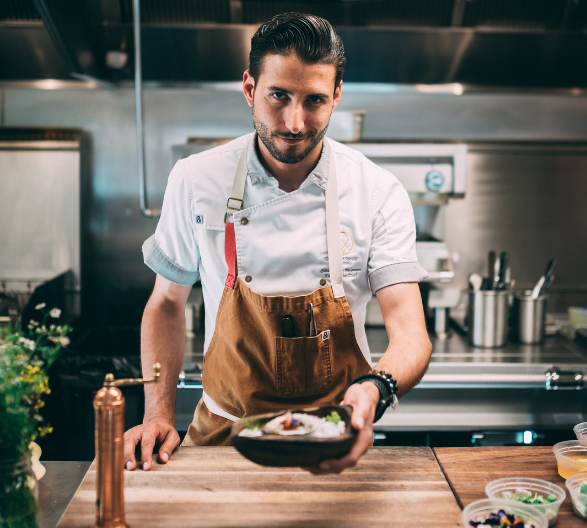 Chef Holding Out A Plate of Food