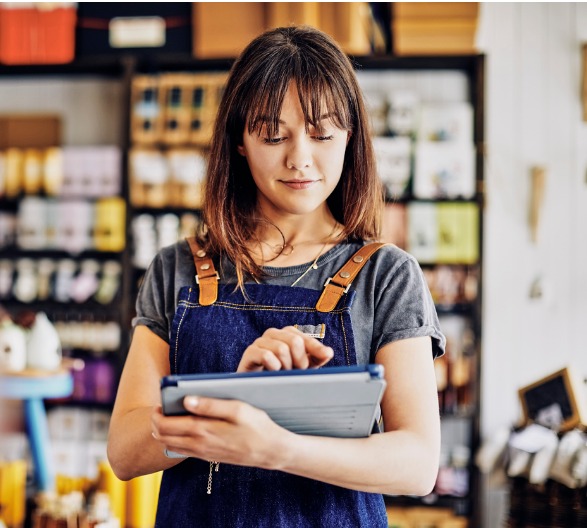 Young business owner looking at commercial real estate loans on her iPad.