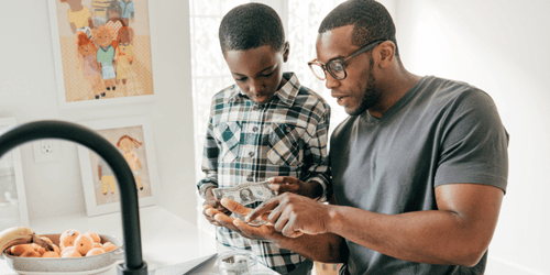 Father helping his son count money