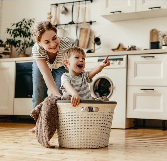 Mother and son in updated home improvement laundry room.