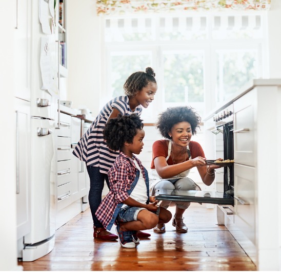 Mother and children cooking in the kitchen after getting a home improvement loan.