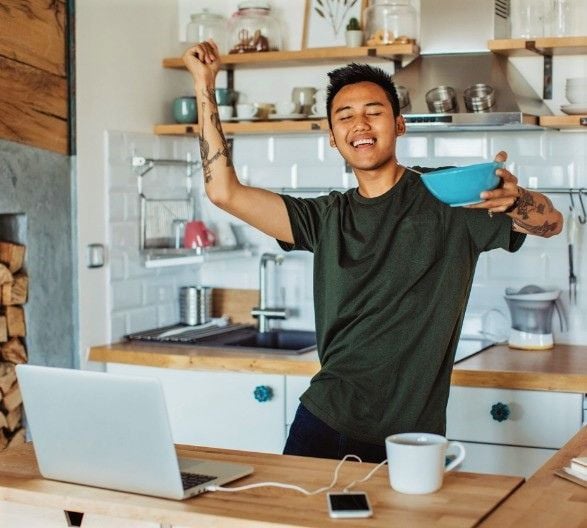 Man dancing happily in the kitchen