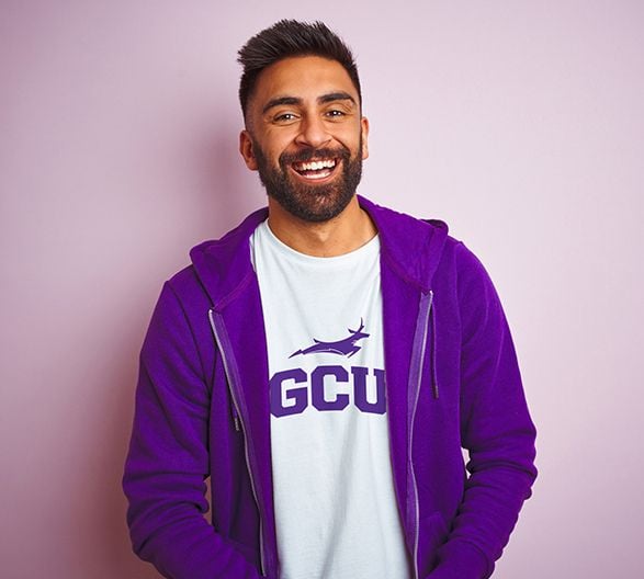 Man in Purple Hoodie and GCU Shirt Smiling