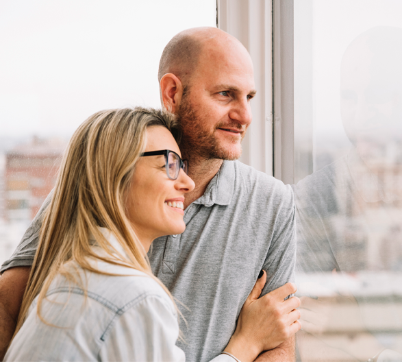 couple smiling looking outside window