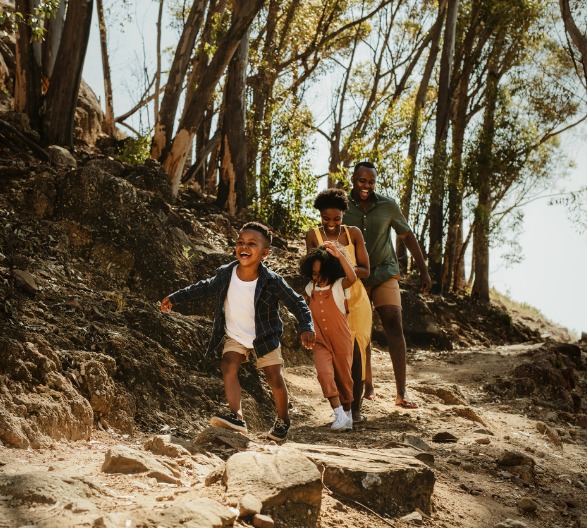 family-running-down-rocky-trail