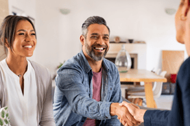 multiethnic couple handshake with consultant at home