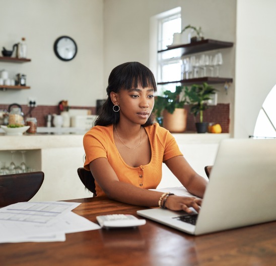 Woman using her laptop to apply for a Personal Loan.