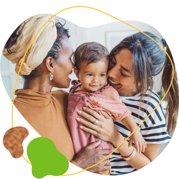 Two mothers together with their baby daughter smiling