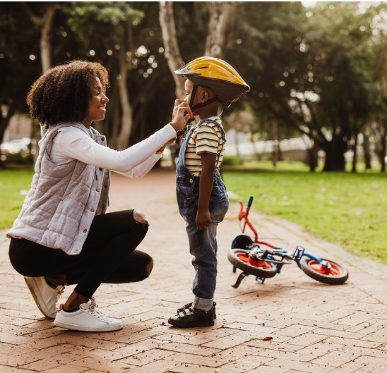 Mother helping son ride a bike
