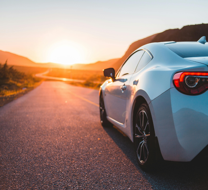 Luxury-car-driving-into-sunset