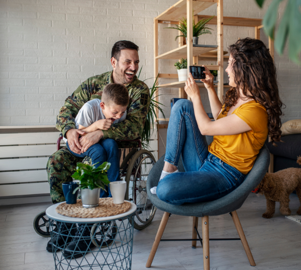 Veteran father in wheelchair with wife and son