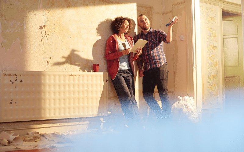  Couple working together on a home renovation project and discussing their plans.