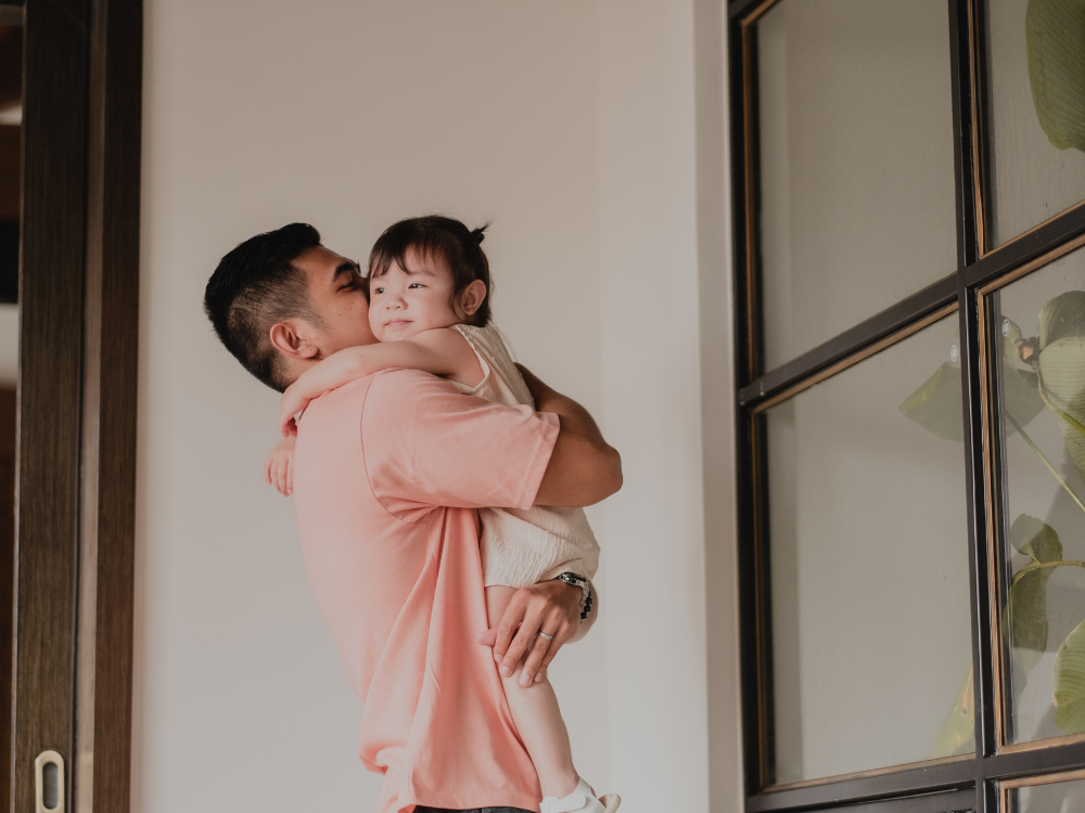 A father holding his daughter
