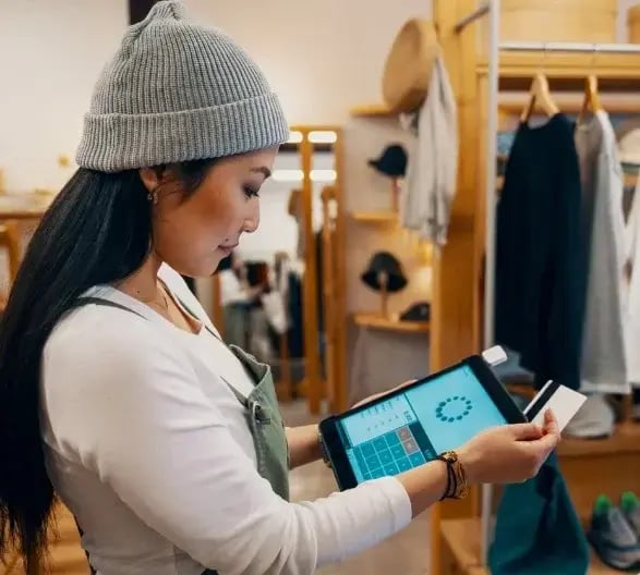 Business Woman Using a Credit Card in Her Shop (1)