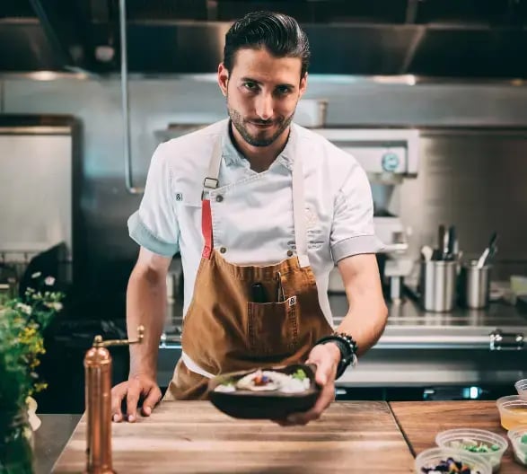Chef Holding Out A Plate of Food (1)