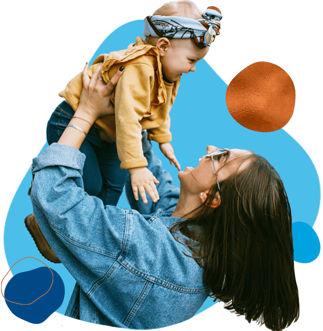 woman holding child up in the air