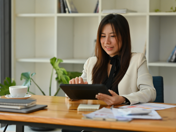 Woman on tablet sitting at desk