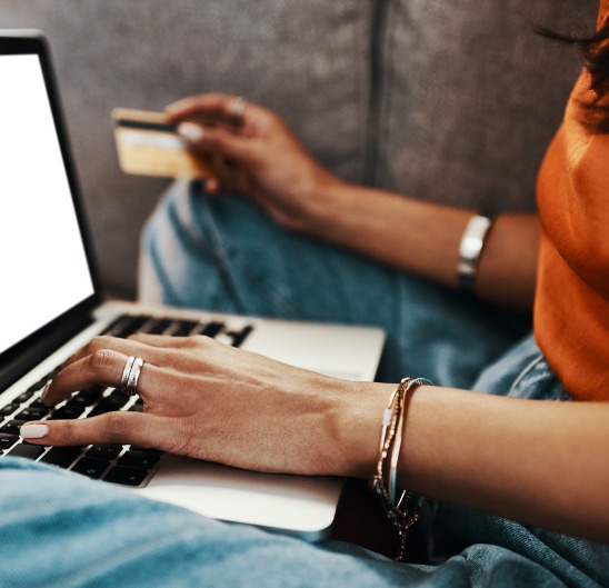 Woman using her card and computer