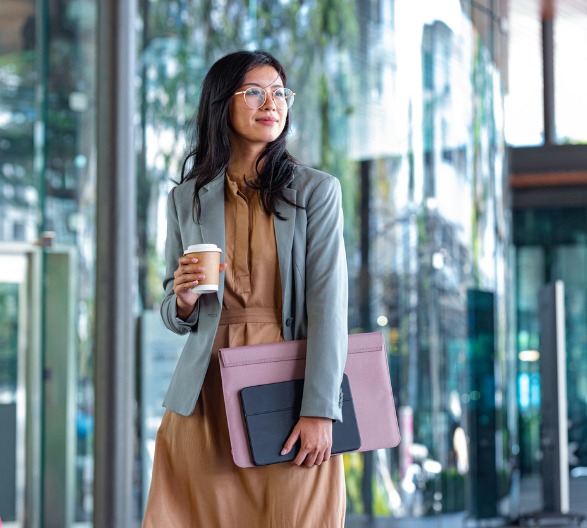 happy-successful-asian-businesswoman-holding-a-takeaway-coffee-cup-picture-id1215174668