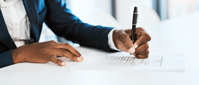 man-signing-car-buying-paperwork