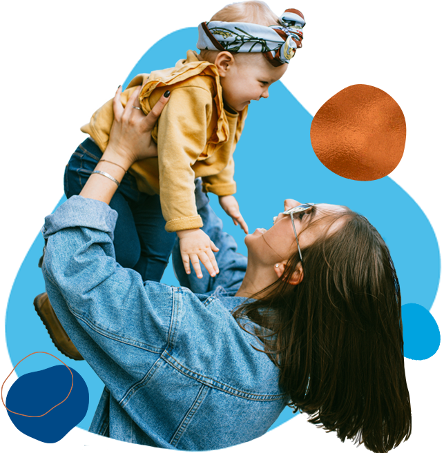 Woman holding child up in the air after getting approved for a mortgage.