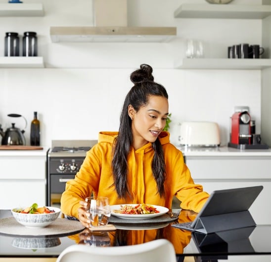 woman-using-digital-tablet-while-having-breakfast