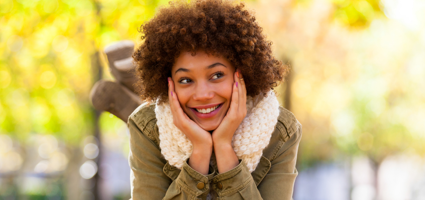 girl-holding-face-in-hands-smiling