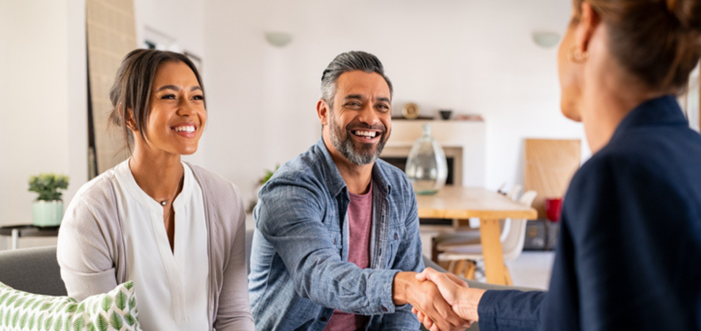 multiethnic couple handshake with consultant at home